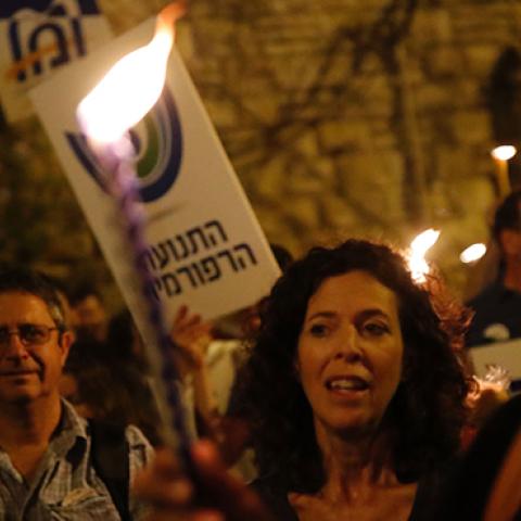 Israeli protesters demonstrate against a government decision to abandon a deal to allow women and men to pray together at the Western Wall, July 1, 2017 (THOMAS COEX/AFP/Getty Images)