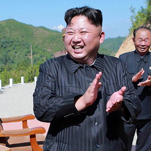 Kim Jong-Un celebrating the successful test-fire of the intercontinental ballistic missile Hwasong-14, July 4, 2017 (STR/AFP/Getty Images)