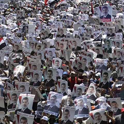 Muslim Brotherhood supporters carry portraits of ousted president Mohamed Morsi outisde Rabaa al-Adawiya mosque in Cairo, July 26, 2013 (MOHAMED EL-SHAHED/AFP/Getty Images)