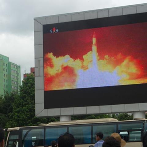 People watch as coverage of an ICBM missile test is displayed on a screen in a public square in Pyongyang, July 29, 2017 (KIM WON-JIN/AFP/Getty Images)