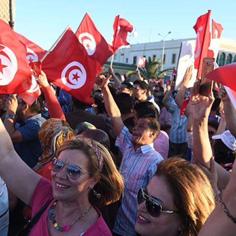 Tunisians hold flags during a demonstration in solidarity with Prime Minister Youssef Chahed in his fight against corruption, May 26, 2017 (FETHI BELAID/AFP/Getty Images)