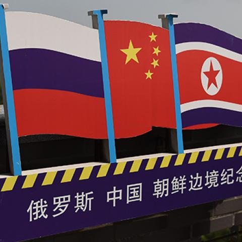 Russian, Chinese, and North Korean flags on the border between the three countries, June 25, 2015 (GREG BAKER/AFP/Getty Images)