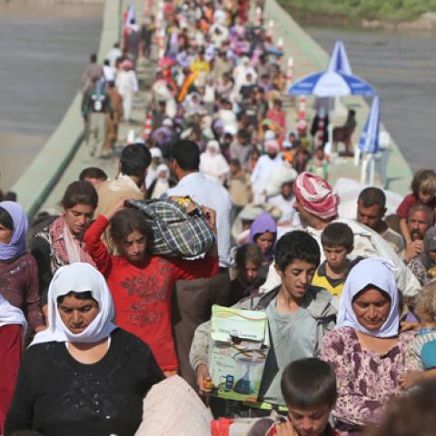 Displaced Yazidis cross the Syrian-Iraqi border, August 13, 2014 (AHMAD AL-RUBAYE/AFP/Getty Images)