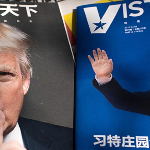 Magazines featuring front pages of US President Donald Trump and China's President Xi Jinping displayed at a news stand in Beijing, April 6, 2017 (NICOLAS ASFOURI/AFP/Getty Images)
