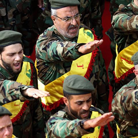 Hezbollah fighters salute during funeral for comrades killed in Syria, November 8, 2017 (MAHMOUD ZAYYAT/AFP/Getty Images)