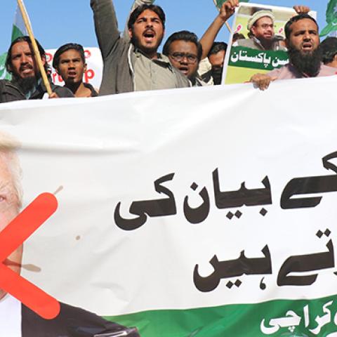 Protesters hold anti-Trump signs after his statement on Pakistan, January 2, 2018 (Sabir Mazhar/Anadolu Agency/Getty Images)