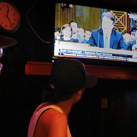 People watch a television broadcast in a bar as Brett Kavanaugh testifies during the Senate hearing over his Supreme Court nomination September 27, 2018 (Mario Tama/Getty Images)
