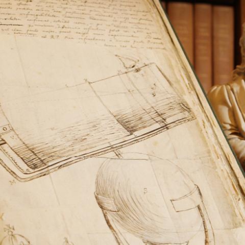  A drawing by Isaac Newton of his telescope next to a statue of him at the Royal Society in London, November 24, 2009 (Peter Macdiarmid/Getty Images)