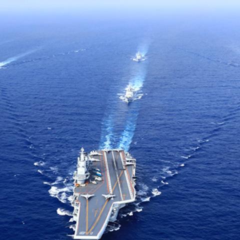 A PLA Navy fleet including the aircraft carrier Liaoning, vessels and fighter jets take part in a drill in April 2018 in the South China Sea. (Photo by VCG)