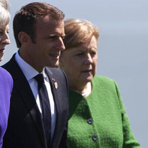 British Prime Minister Theresa May, French President Emmanuel Macron, and German Chancellor Angela Merkel arrive for a family photo during the G7 Summit in in La Malbaie, Quebec, Canada, June 8, 2018. (Photo by GEOFF ROBINS / AFP) (Photo credit should rea