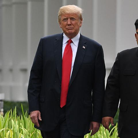 North Korea's leader Kim Jong Un walks with U.S. President Donald Trump during a break in talks at their historic US-North Korea summit, at the Capella Hotel on Sentosa island in Singapore on June 12, 2018. (SAUL LOEB/AFP/Getty Images)