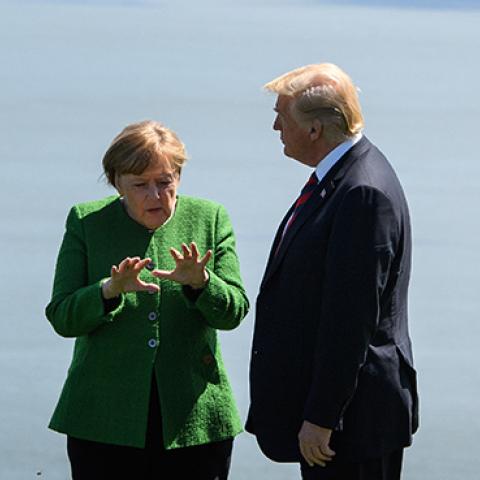 Germany's Chancellor Angela Merkel and U.S. President Donald Trump speak together on the first day of the G7 Summit, on June 8, 2018 in La Malbaie, Canada. (Leon Neal/Getty Images)