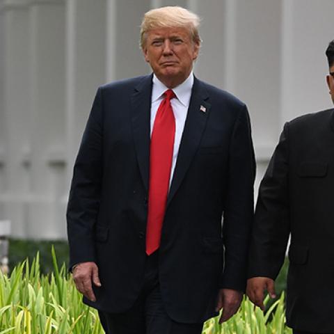 North Korea's leader Kim Jong Un walks with U.S. President Donald Trump during a break in talks at their historic US-North Korea summit, in Singapore on June 12, 2018. (SAUL LOEB/AFP/Getty Images)