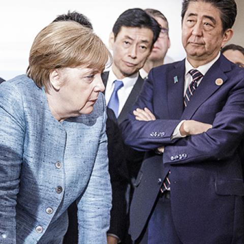 German Chancellor Angela Merkel deliberates with U.S. President Donald Trump on the sidelines of the official agenda on the second day of the G7 summit on June 9, 2018 in Charlevoix, Canada. (Jesco Denzel /Bundesregierung/Getty Images)
