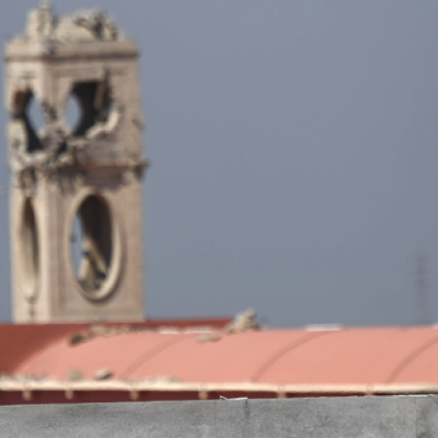 A Syriac Christian militiaman stands guard on top of a building at the Saint John's church (Mar Yohanna) in the nearly deserted predominantly Christian Iraqi town of Qaraqosh, on April 16, 2017.(CHRISTOPHE SIMON/AFP/Getty Images)