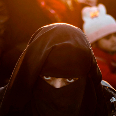 A woman looks on as she waits to be searched by members of the Kurdish-led Syrian Democratic Forces (SDF) after leaving the Islamic State (IS) group's last holdout of Baghouz, in the eastern Syria, March 1, 2019. (DELIL SOULEIMAN/AFP/Getty Images)