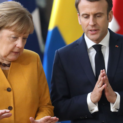 Germany's Chancellor Angela Merkel and France's President Emmanuel Macron (R) talk to each other prior to pose for a family photo on March 22, 2019 in Brussels at the end of an EU summit focused on Brexit. (LUDOVIC MARIN/Getty Images)