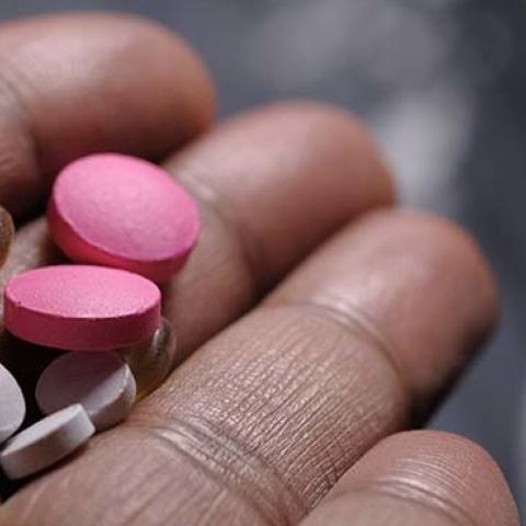 Opioid epidemic and drug abuse concept with a heroin syringe and pills
