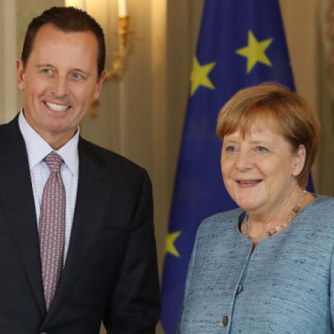 U.S. Ambassador Richard Grenell poses for a photo with German Chancellor Angela Merkel at Schloss Meseberg palace on July 6, 2018 near Gransee, Germany. (Sean Gallup/Getty Images)