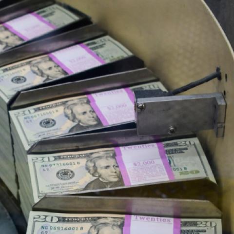 Packs of freshly printed 20 USD notes are processed for bundling and packaging at the US Treasury's Bureau of Engraving and Printing in Washington, DC July 20, 2018. (EVA HAMBACH/Getty Images)