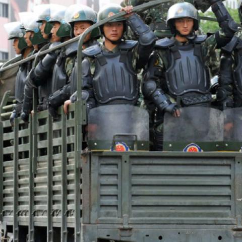 Trucks carrying armed police officers run towards the residential area of Uighur people on July 8, 2009 in Urumqi, the capital of Xinjiang Uighur autonomous region, China. (The Asahi Shimbun/Getty Images)