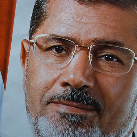 A protester holds a poster of Mohammed Morsi during a protest against the mass execution sentence of 529 supporters of Morsi and the Muslim Brotherhood on March 28, 2014. (Rahman Roslan/Getty Images)