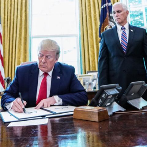 US President Donald Trump signs with US Vice President Mike Pence and US Secretary of Treasury Steven Mnuchin at the White House on June 24, 2019, 'hard-hitting sanctions' on Iran's supreme leader. (MANDEL NGAN/AFP/Getty Images)