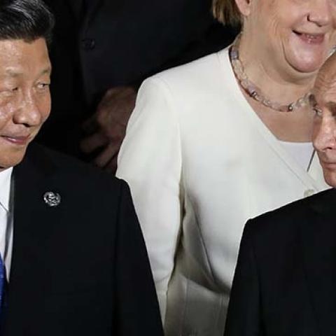 Russian President Vladimir Putin (front R) and Chinese President Xi Jinping as they arrive to pose for a group photo before a cultural event at the Osaka Geihinkan in Osaka Castle Park during the G20 Summit in Osaka. (Getty Images)