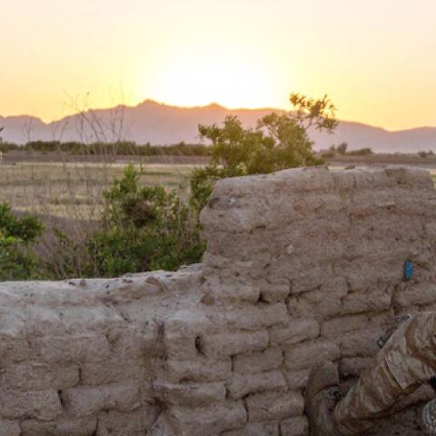 An Afghan Commando keeps an eye on the horizon at the end of the day in Pesaw village, Bala Balouk district, Farah province, Afghanistan, May 21, 2018. (NATO photo by Lt. Amy Forsythe)