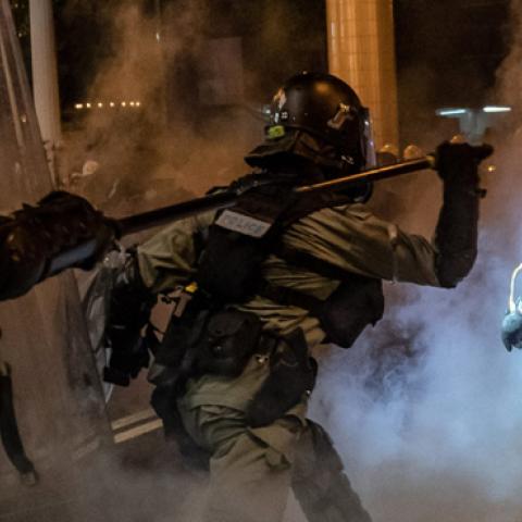 Riot police charge toward protesters in a fume of tear gas on an express way at Causeway Bay district on August 4, 2019 in Hong Kong, China. (Anthony Kwan/Getty Images)