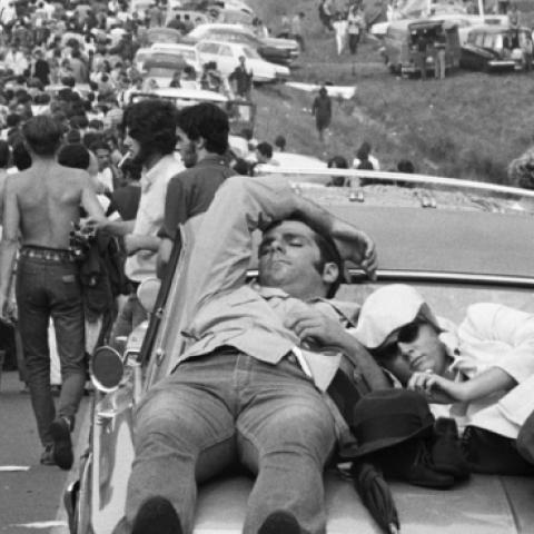 On foot, in cars, atop cars, young people leave the Woodstock Music Festival. (Getty Images)