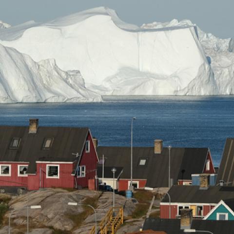 Icebergs floating at the mouth of the Ilulissat Icefjord loom behind the town center on July 30, 2019 in Ilulissat, Greenland. (Sean Gallup/Getty Images)