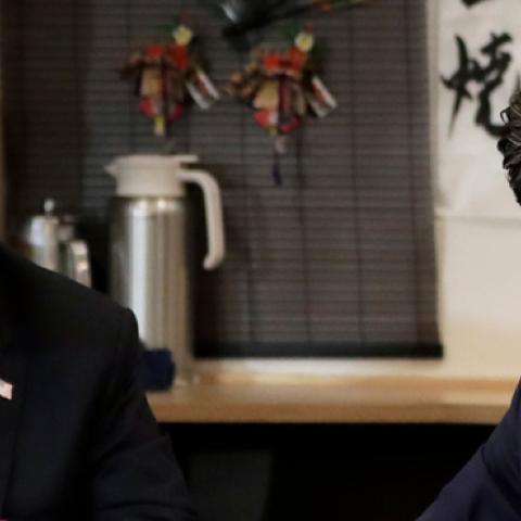 Shinzo Abe, Japan's Prime Minister, right, speaks as U.S. President Donald Trump looks on while sitting at a counter during a dinner at the Inakaya restaurant in the Roppongi district on May 26, 2019 in Tokyo, Japan. (Pool/Getty Images)