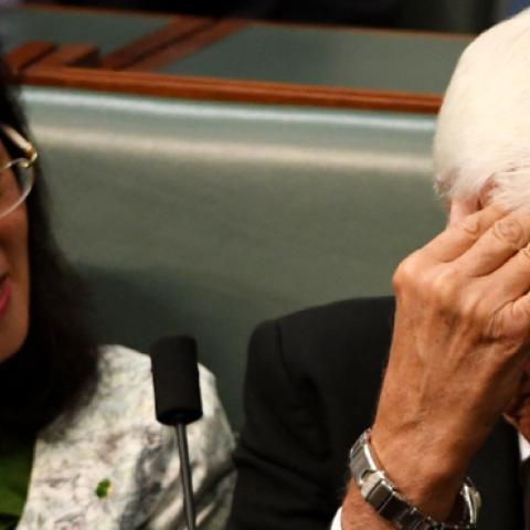 Independent MP Bob Katter hides his face as he sits next to Liberal backbencer Gladys Liu during a division in Question Time in the House of Representatives on September 16, 2019 in Canberra, Australia. (Getty Images)