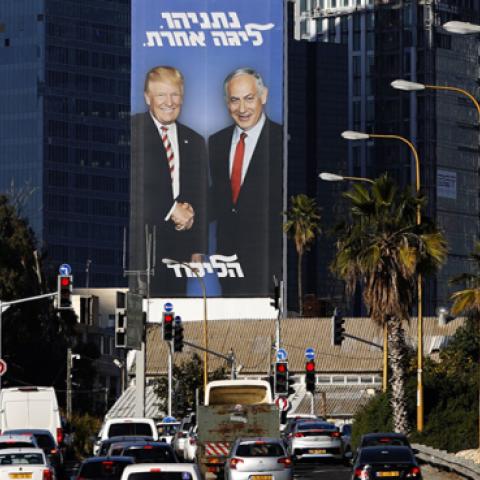 A picture taken on February 3, 2019 in the Israeli coastal city of Tel Aviv shows a giant election billboard of Israeli Prime Minister Benjamin Netanyahu and US President Donald Trump shaking hands. (JACK GUEZ/Getty Images)