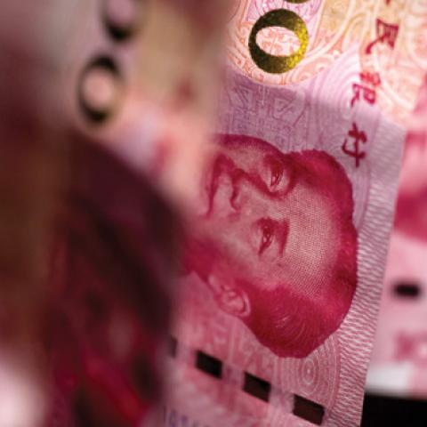 Chinese one-hundred yuan banknotes sit on a black background in this arranged photograph in Hong Kong, China. (Bloomberg/Getty Images)