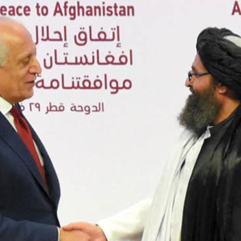 Taliban co-founder Mullah Abdul Ghani Baradar (R) and U.S. Special Representative for Afghanistan Reconciliation Zalmay Khalilzad (L) shake hands as they exchange peace agreement documents during the signing ceremony on February 29, 2020 in Doha, Qatar