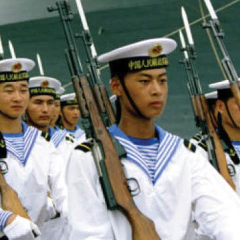 Sailors of the People’s Liberation Army Navy march past the USS Blue Ridge (LCC 19), at the time the United States Seventh Fleet flagship homeported in Yokosuka, Japan.