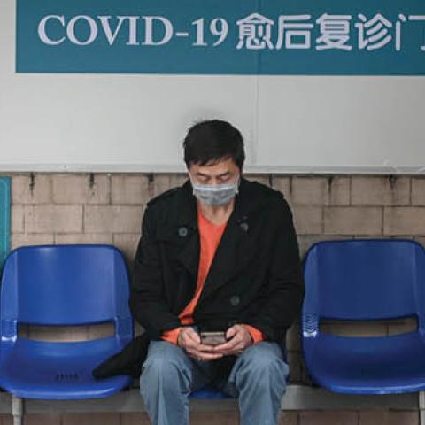 A cured coronavirus patient waits outside an outpatient department of Guangdong Second Provincial General Hospital on March 4, 2020 in Guangzhou, Guangdong Province of China. The hospital sets up the department especially for cured patients to better moni