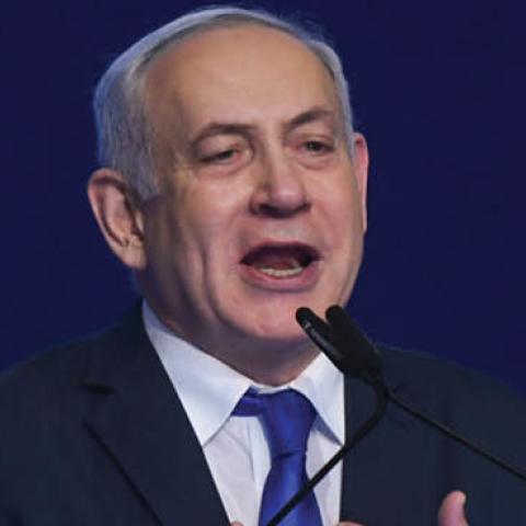 Israeli Prime Minister Benjamin Netanyahu gestures as he speaks to supporters following the announcement of exit polls in Israel's election at his Likud party headquarters in Tel Aviv.