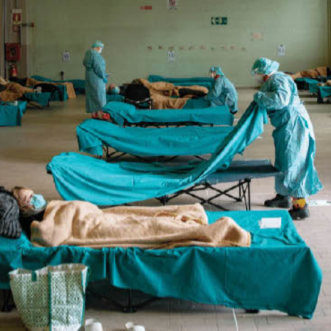 Medical personnel care for patients in an emergency temporary room, set up to ease pressure on the healthcare system, at a hospital in Brescia, Italy, on Friday, March 13th, 2020. 
