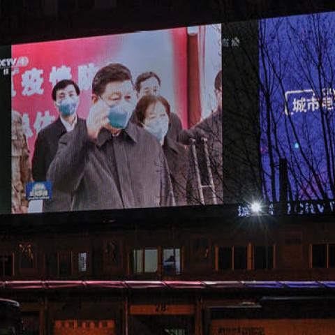  A large screen in the street shows Chinese president Xi Jinping wearing a protective mask during his visit to Wuhan earlier in the day, the epicentre of the coronavirus, on CCTV's evening newscast on March 10, 2020 in Beijing, China. 