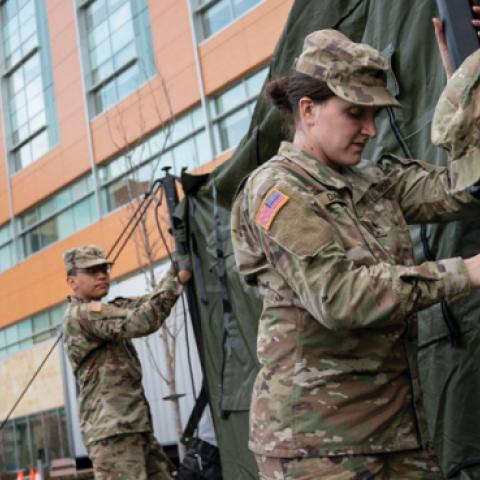 Members of the Maryland Army National Guard work to set up a triage tent in the parking lot outside of the emergency room at Adventist HealthCare White Oak Medical Center on March 19, 2020 in Silver Spring, Maryland. (Drew Angerer/Getty Images)