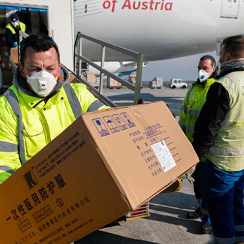 Some 130 tons of protective gear is unloaded an Austrian Airline airplane arrived from China and bound for Italy at Vienna Airport in Schwechat, Lower Austria on March 23, 2020. (GEORG HOCHMUTH/APA/AFP via Getty Images)