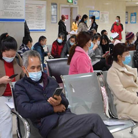 People wait to see doctors in Enshi Central Hospital in Enshi, central China's Hubei Province, March 29, 2020. 