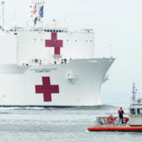 The Military Sealift Command hospital ship USNS Comfort (T-AH 20) is escorted by U.S. Coast Guard, New York Police Department and New York Fire Department assets as the ship arrives in in New York City, March 30, 2020