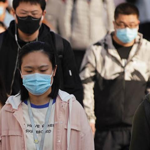 Commuters wear protective masks as they exit a train at a subway station during Monday rush hour on April 13, 2020 in Beijing, China