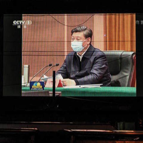 A large screen in the street shows Chinese president Xi Jinping wearing a protective mask during his visit to Wuhan earlier in the day, the epicentre of the coronavirus, on CCTV's evening newscast on March 10, 2020 in Beijing, China.