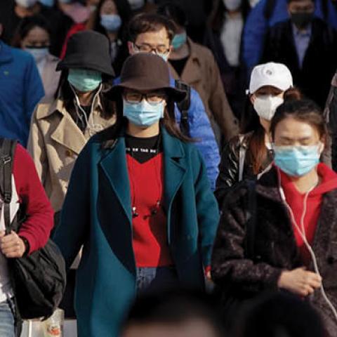 Commuters wear protective masks as they exit a train at a subway station during Monday rush hour on April 13, 2020 in Beijing, China