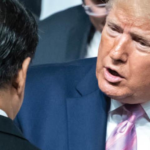 Xi Jinping, President of China, and Donald Trump, President of the United States of America (USA), chat as they pose for the group photo at the beginning of the G20 summit. 
